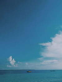 Scenic view of sea against blue sky