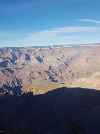 Scenic view of dramatic landscape against blue sky