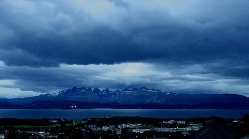 Scenic view of mountains against cloudy sky