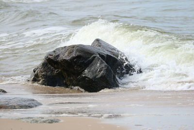 Waves splashing on rocks at beach