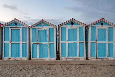 Little blue houses on the beach. sunset on the mediterranean coast. old cracked paint