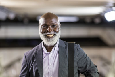 Smiling bald senior businessman wearing suit