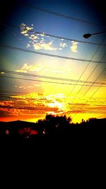 Silhouette of power lines at sunset