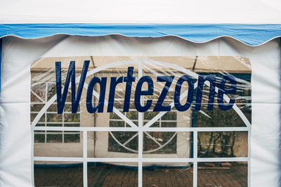 Text waiting zone in german language on tent. schrift wartezone auf zelt