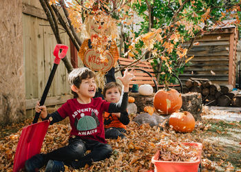 Children playing with leaves in autumn