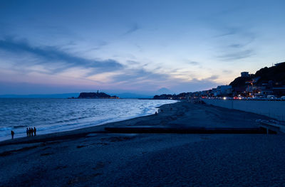 View of beach against cloudy sky