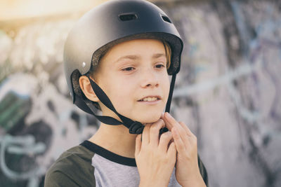 Close-up of boy wearing skateboard helmet