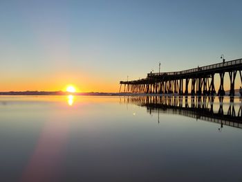 Scenic view of sea against clear sky during sunset