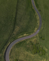 Aerial view of road amidst green landscape