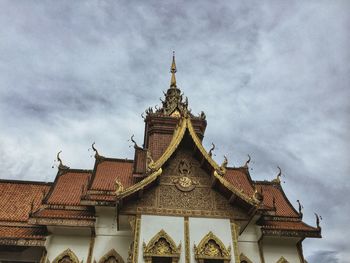 Low angle view of temple building against cloudy sky