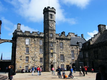 Group of people in historic building against sky