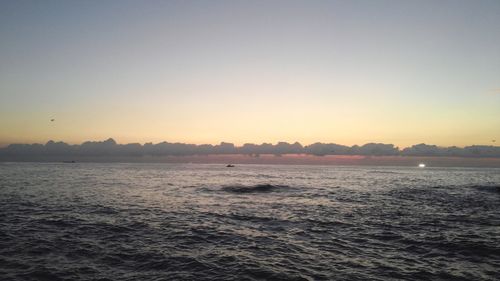 Scenic view of sea against clear sky during sunset