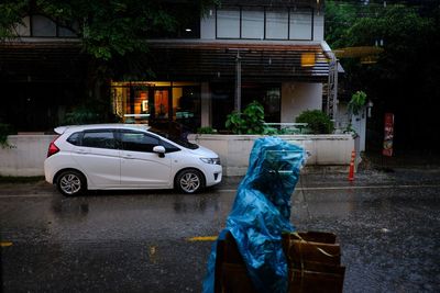 Man with umbrella on street in rainy season