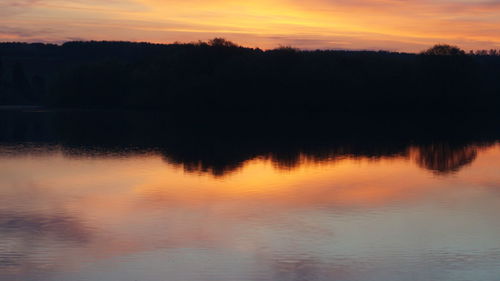 Scenic view of lake at sunset