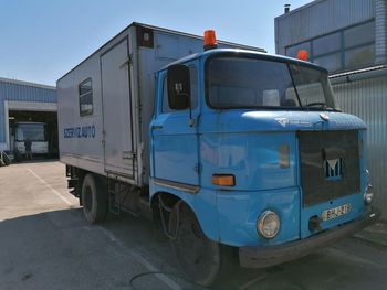 View of vehicles on road along buildings