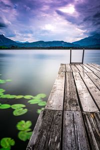 Wooden pier over lake against sky