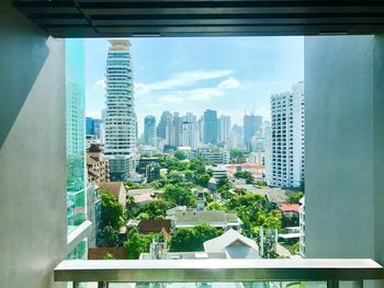 Cityscape against sky seen through window