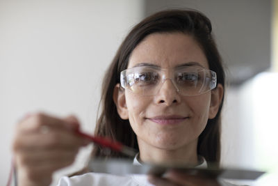 Scientist female with lab glasses and sample in a lab