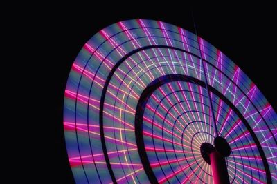 Low angle view of illuminated ferris wheel