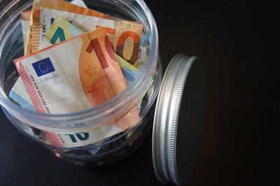 Close-up of currency in jar on table