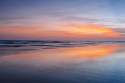 Scenic view of sea against romantic sky at sunset