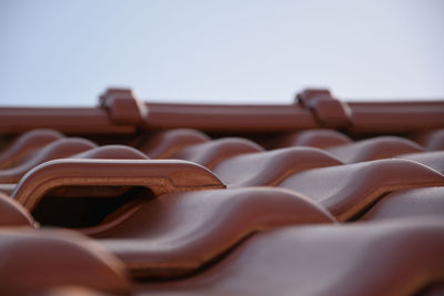 Close-up of chairs on roof against clear sky