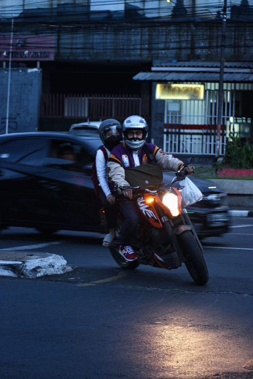 PEOPLE ON ROAD AT NIGHT