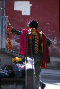Rear view of woman standing on street