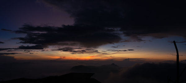 Low angle view of silhouette mountain against dramatic sky