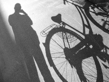 Shadow of man riding bicycle