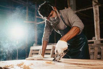 Confident wood worker expert.carpenter working at factory.