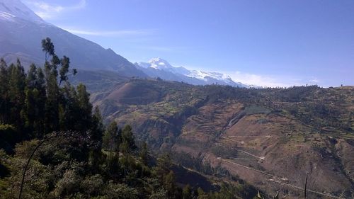 Scenic view of mountain range against blue sky