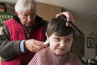 Close-up of a boy getting a haircut at the barber