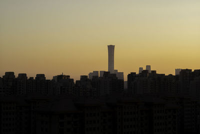 Modern buildings against clear sky during sunset