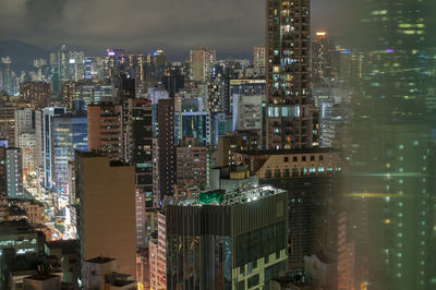 High angle view of illuminated buildings in city at night