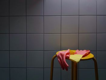 Close-up of multi colored rubber gloves on chair