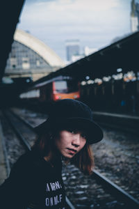 Portrait of woman standing on railroad station platform