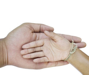 Close-up of hands over white background