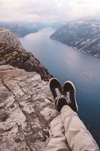 Low section of person relaxing on rock