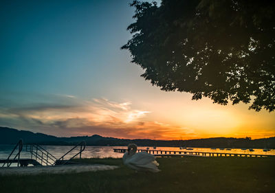 Scenic view of lake against sky during sunset