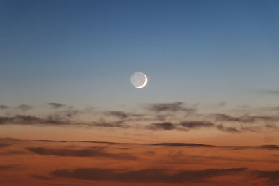 Low angle view of moon against sky during sunset