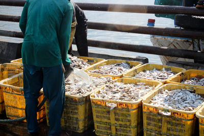 Full length of man standing at fish in factory
