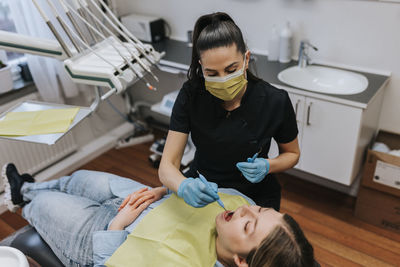 Female dentist with patient in dentist's office