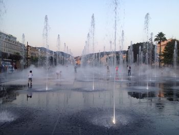 Panoramic view of people in city against sky