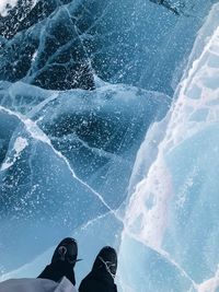 Low section of person standing on glacier