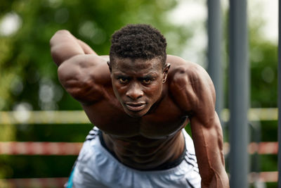 Portrait of young man exercising in park