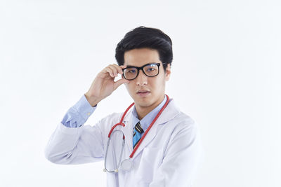 Young man wearing mask against white background