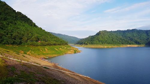 Scenic view of lake and mountains against sky