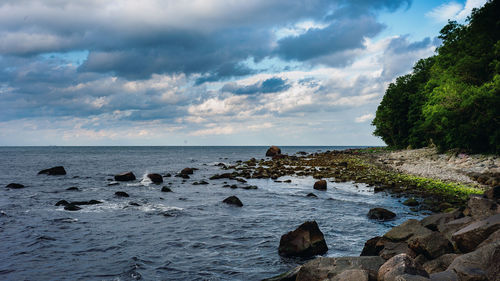 Rocks on beach against sky