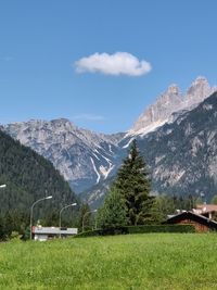 Scenic view of field and mountains against sky